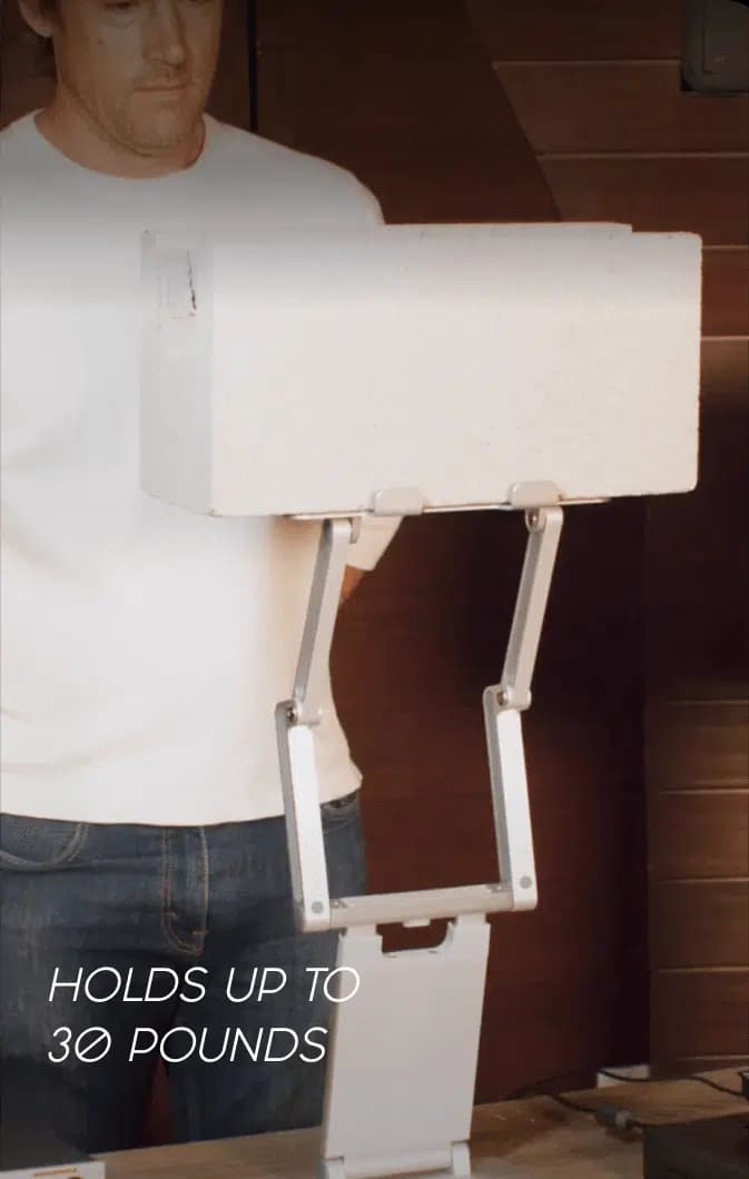 Heavy box resting on a DriftDesk, demonstrating its 30-pound capacity