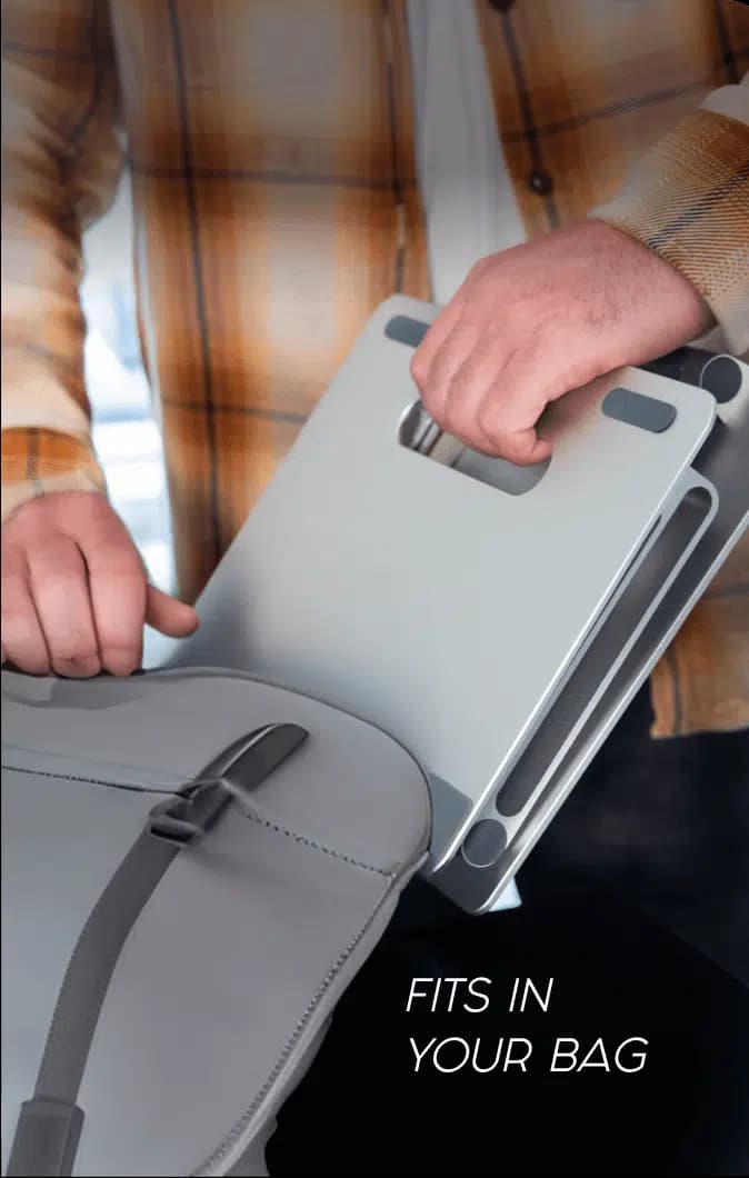 A folded DriftDesk sliding into a shoulder bag